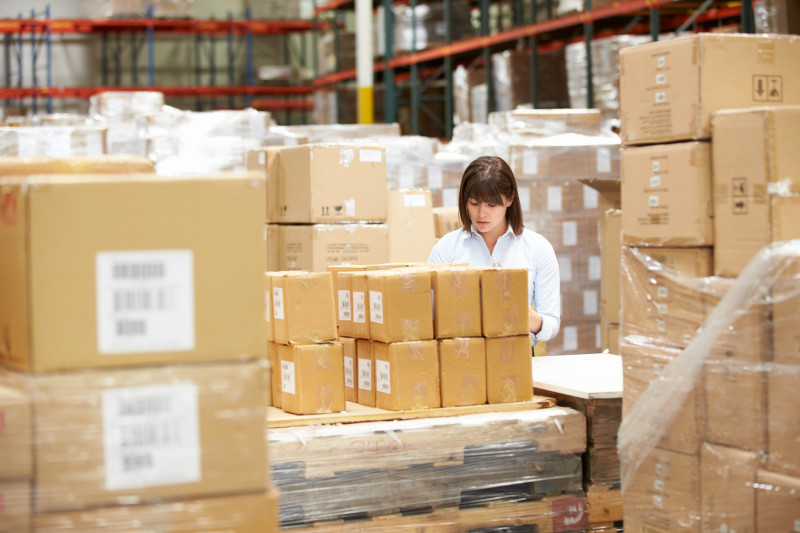 Worker In Warehouse Preparing Goods For Dispatch